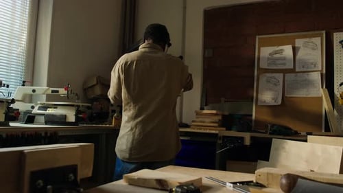 Carpenter Working with Drill Press Machine in Workshop