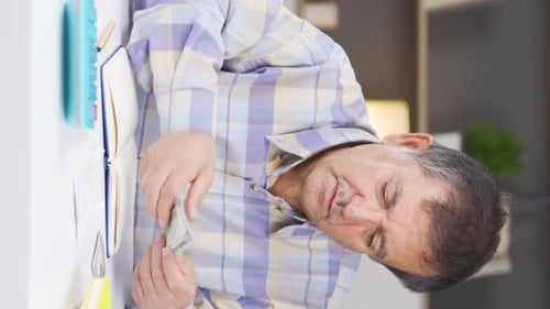 Smiling Man Counting Money at Home