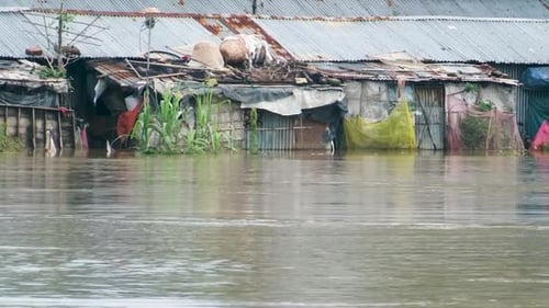 Houses in the Slum Near the River Were Inundated by Floodwaters in Bangladesh, South Asia - Pan Righ