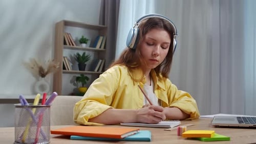Focused Student Engaged in Online Learning with Laptop and Headphones