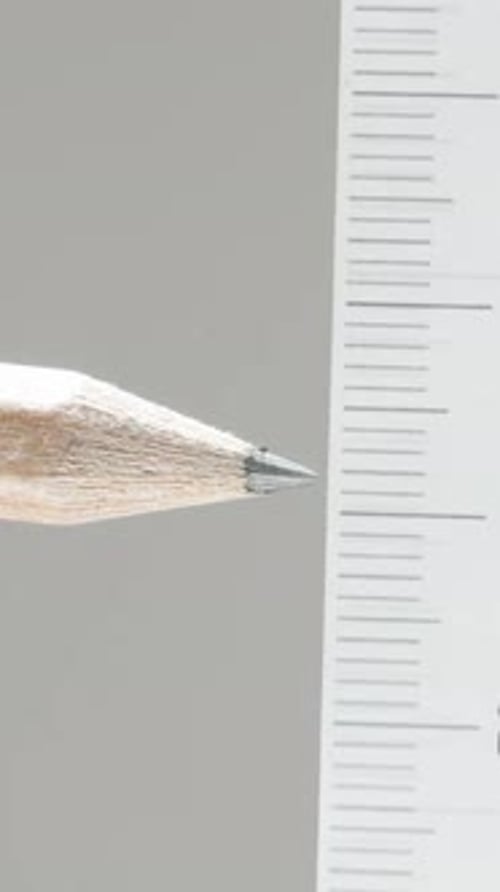 Vertical video. We measure the distance opposite to the pencil with a ruler, the concept of building