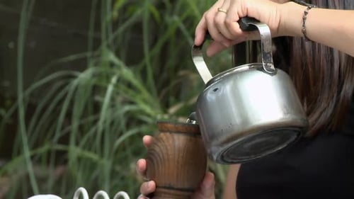 A Woman Drinking Yerba Mate in the Backyard of Her House in Buenos Aires, Argentina. Close Up.