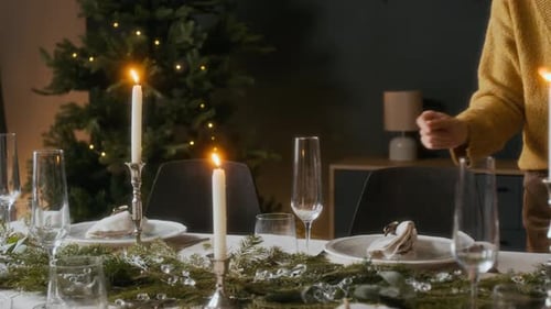 Woman Setting Elegant Holiday Dinner Table at Home
