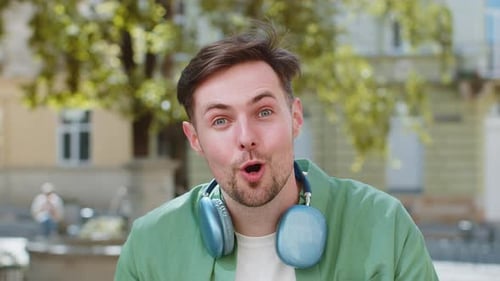 Man Reacts with Joy and Surprise in City