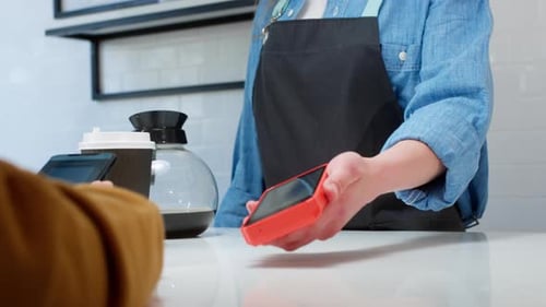 Closeup a Customer Makes a Purchase in a Coffee Shop Pays with a QR Code Scans the QR Code with a