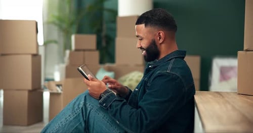 Moving, tablet and man in new home with boxes for interior designing with online shopping