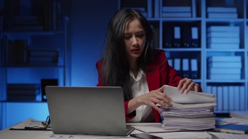 Businesswoman is seriously stressed working overtime bored and burnout due to office syndrome