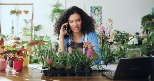 Woman on Phone Discussing Plants in Shop