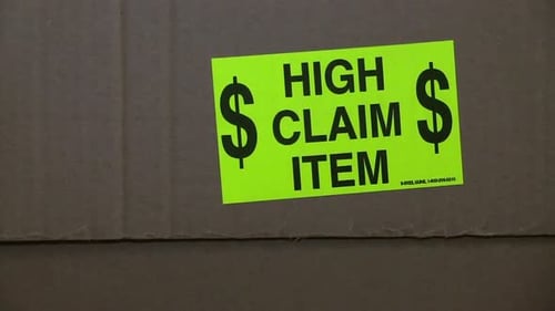 Close Up of Shipping Box with High Claim Sticker