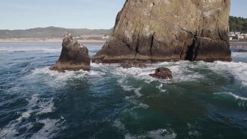 White capped waves crash against Haystack Rock in Oregon