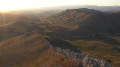Aerial View Of Cliffs Mountains And Road At Sunset
