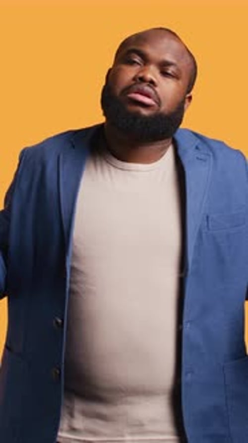 Vertical Video Man Shrugging Shoulders Not Caring Studio Background