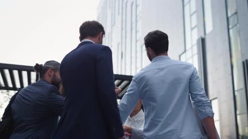 Business team celebrates success with fist bump in city