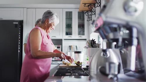 Senior Couple Preparing Food Together in Kitchen