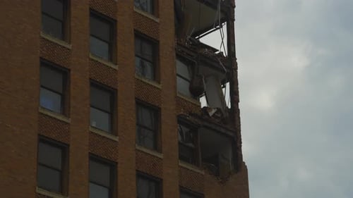 A wrecking ball swings into a high-rise building during its demolition in Youngstown, Ohio, showing