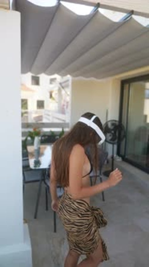 Woman Using VR Headset on Sunny Patio