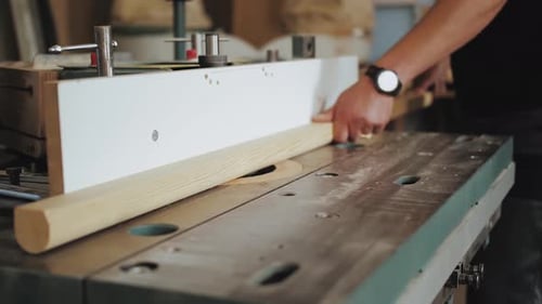 Closeup Hands of a Factory Worker Cuts Wooden Bars on a Circular Saw
