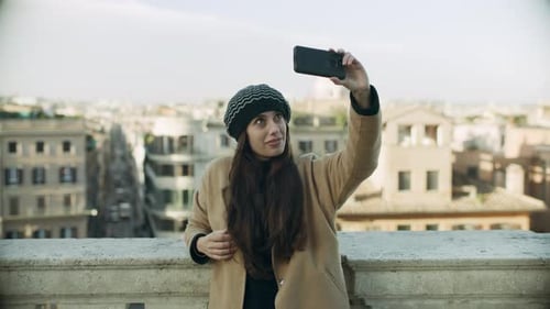 Woman Taking Selfie with Cityscape Background in Rome