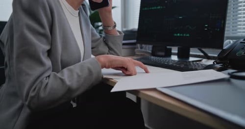 Close Up of Female Financier Working with Paper Documents and Financial Metrics