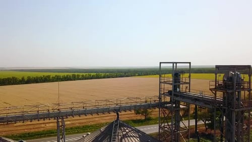 Vue aérienne d'un élévateur à grains devant un champ de blé, drone quadricoptère, caméra volant au-dessus de la farine ou de l'huile