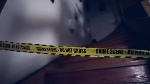 Crime Scene Tape Blocking Access on Wooden Stairs