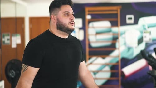Close-up young man jumping rope to improve muscle strength and cardio routine in the gym