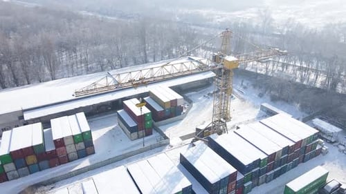 Shipping Container and Cargo Crane at Storage Yard at Winter Time Aerial View