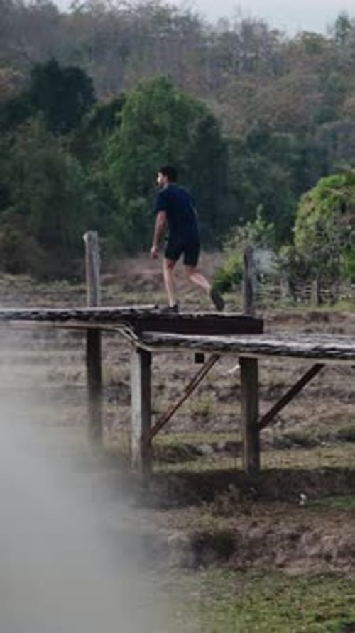 Traveler Walking Wooden Bridge Lush Greenery Enveloping Scenic Pathway