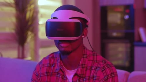 Man Takes Off VR Headset in Lit Room