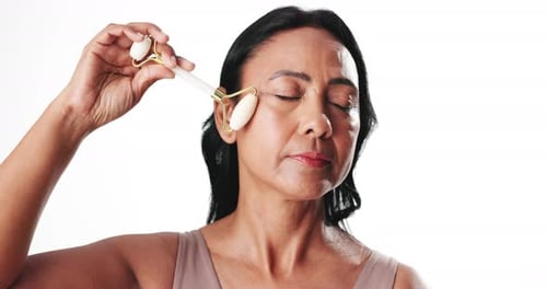 Skincare, roller or face of and woman in studio, facial massage or wrinkle prevention for smooth