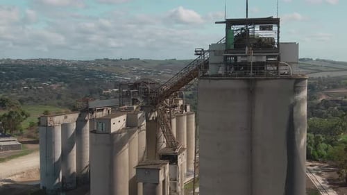 4k Aerial Painted grain silos with city in background Drone close up shot