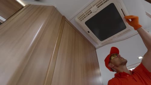 Man Working on RV Air Conditioner Unit