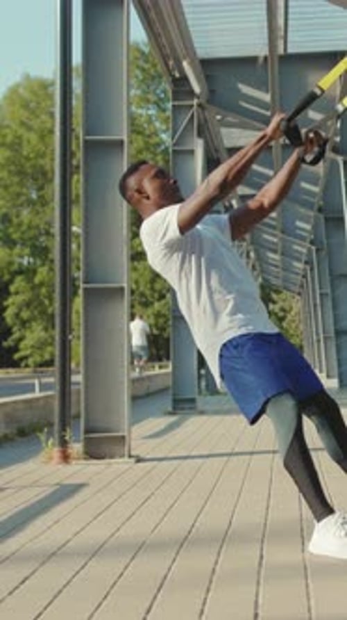 Man Doing Suspension Training Exercise Outdoors