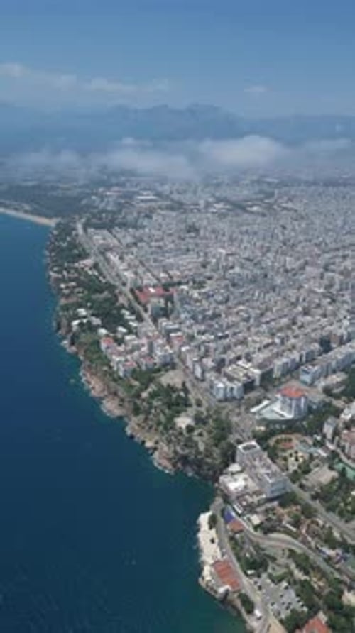 Aerial video high above the coastline and a small marina in the city of Antalya Turkey