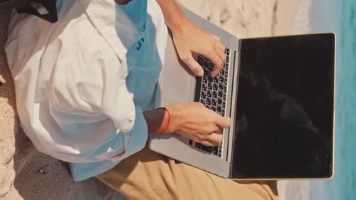 Close Up Hands Man Freelancer Using Laptop Lying on Beach and Working Remotely