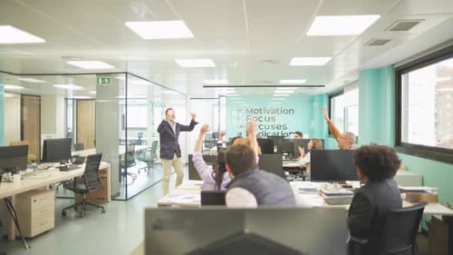 Enthusiastic Manager Motivating Colleagues in a Modern Office