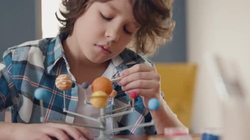 Creative young boy painting cosmos dream with brush concept for future life