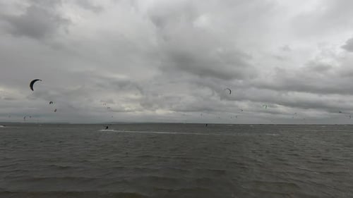 Kitesurfers Enjoying Windy Day at the Beach
