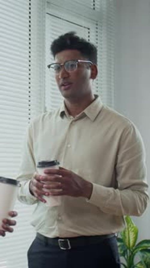 Manager Having Coffee Break with Colleague in Office