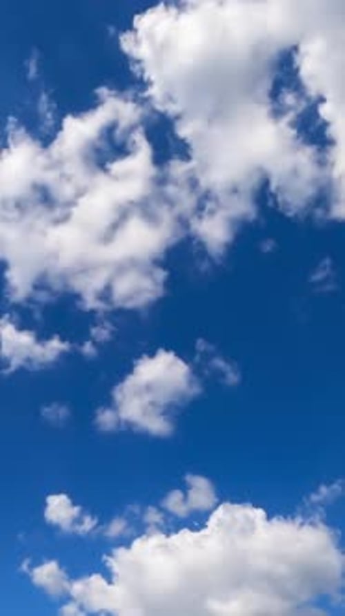 White light soft clouds flying in the sky. Sunny day background. Low angle view. Timelapse.