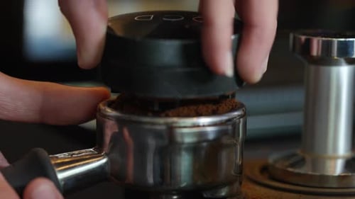 4K Barista making hot coffee on coffee maker at coffee shop.