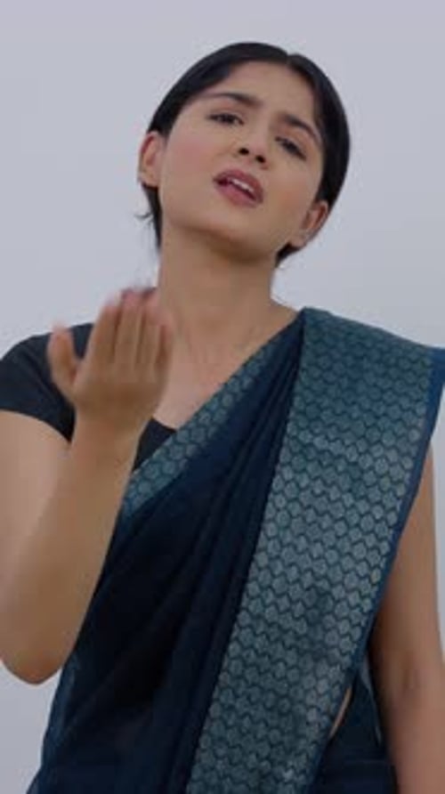 Woman Demonstrates Counting to Five in Sari