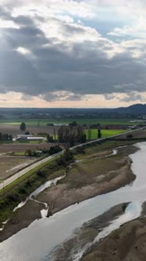 Aerial View Of A Scenic River And Road Through Fields In British Columbia, Canada