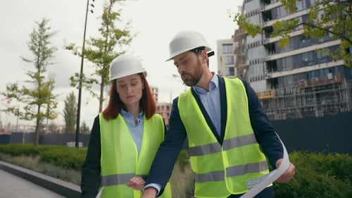 Architects Reviewing Construction Plans On Site