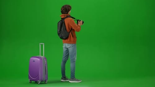 Portrait of Traveler Isolated on Chroma Key Green Screen Background Young Man with Suitcase Standing