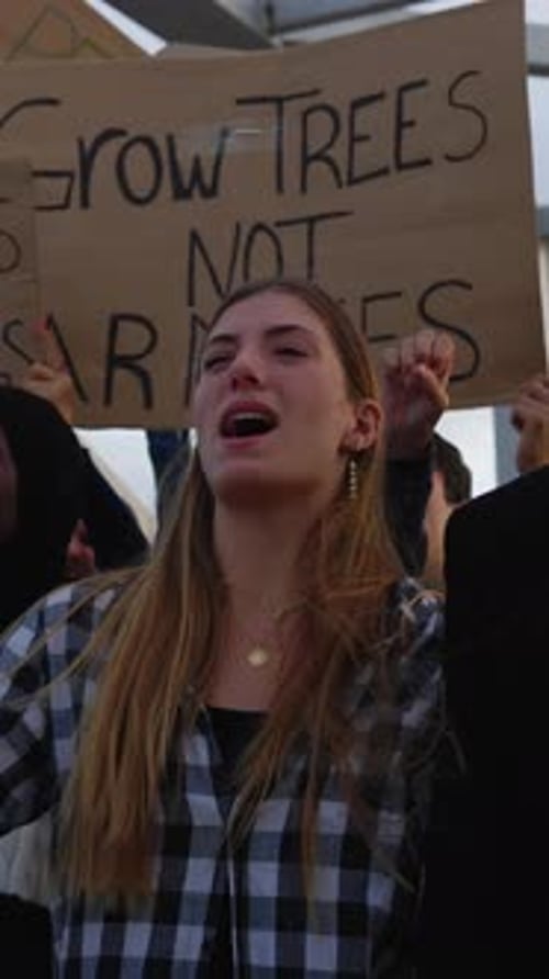 Woman Protesting with a Sign Outdoors