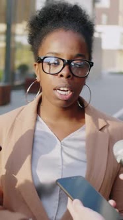 Woman Answering Questions in Urban Interview Setting