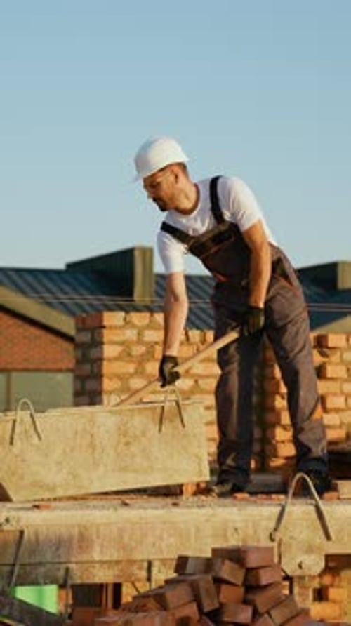 Construction Worker Preparing Cement Mix on Site