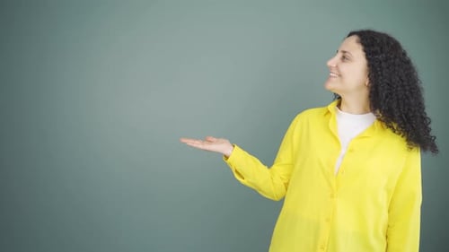 Woman Gesturing and Presenting in Studio Setting