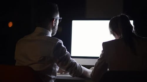 Businesspeople In The Office At Night Working Late.